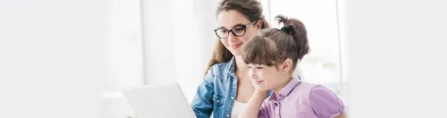 Mother and daughter reading from computer screen
